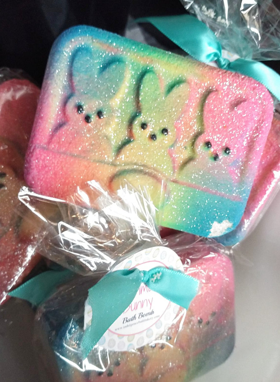 Three Easter peeps on a rectangle bath bomb. Colors are airbrushed in light pink, yellow, and blue.