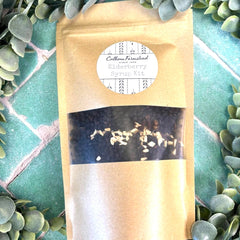 Product packaging with a label on a green leafy background