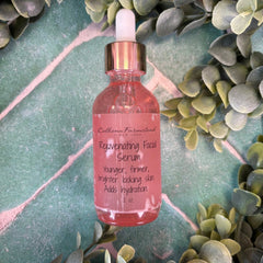 Pink facial serum bottle with dropper on a green leafy background