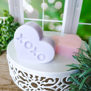 Heart shaped soaps that look like conversation heart candies. XOXO Purple Heart shaped soap.