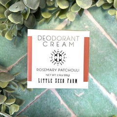 Deodorant cream packaging with 'Little Seed Farm' branding on a green leafy background