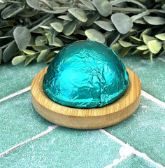 Green foil-wrapped shower steamer eucalyptus in the background
