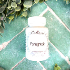 Bottle of Calhoun Fenugreek on a green tiled surface with green leaves. Herbs for womens health. Herb stores near me.