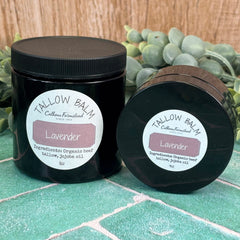 Two jars of Tallow Balm with lavender scent on a green surface.