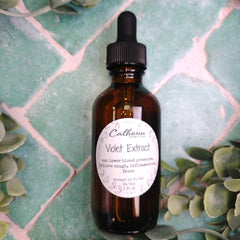 Bottle of Calhoun Remedies Violet Extract on a green patterned background