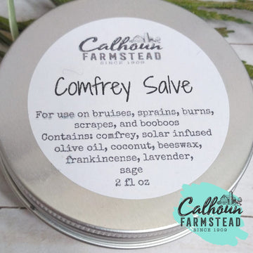 comfrey salve balm in 2oz tin. made with natural ingredients and herbs for healing cuts, bruises and booboos. add to first aid kit, camping kit, and home apothecary. holistic healing.