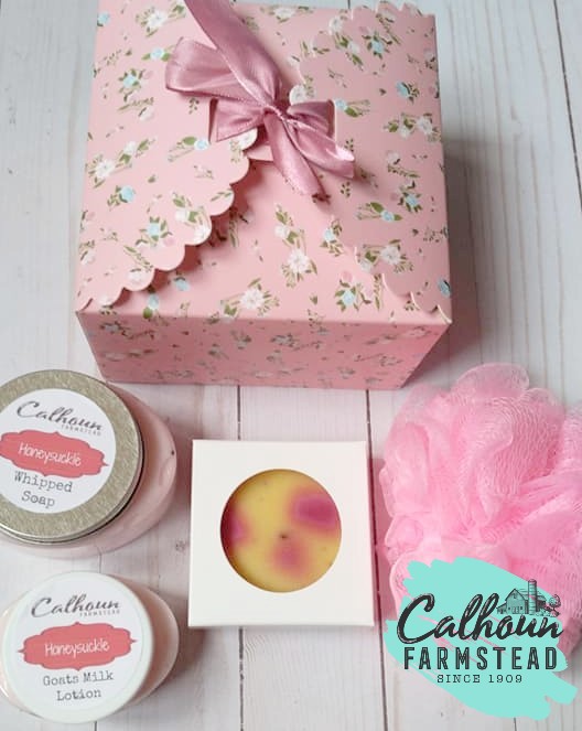flat lay of pink floral gift sets. Self care gift boxes. Gifts for her, Mothers day gifts.